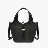 Black woven handbag with leather straps close-up