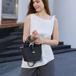 Black woven handbag with leather straps model