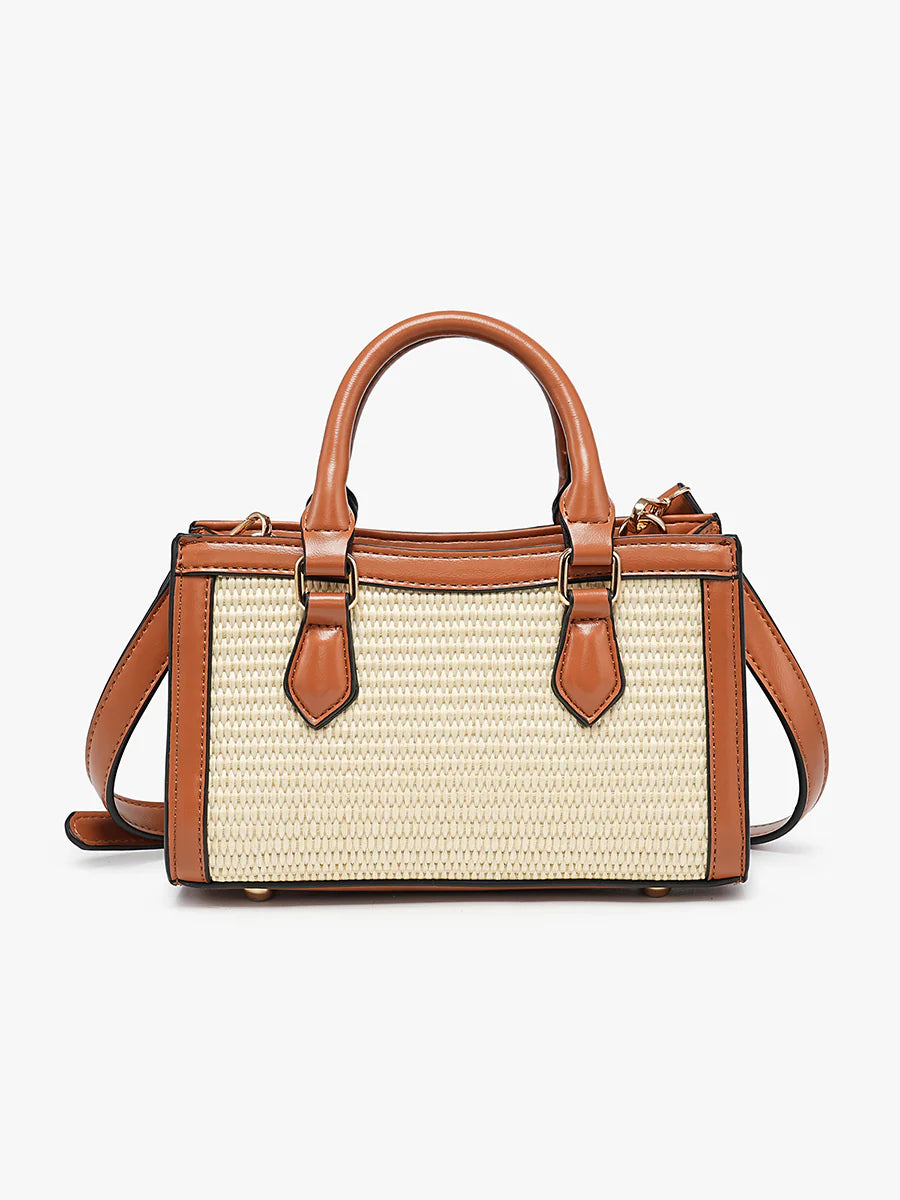 Handbag with straw-like texture and brown leather accents close-up