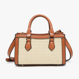 Handbag with straw-like texture and brown leather accents close-up