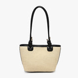 Beige straw handbag with black accents and black shoulder strap close-up