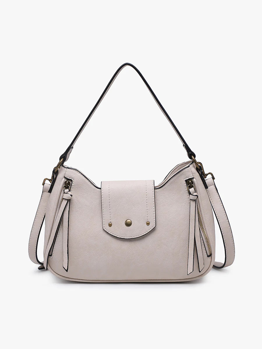 Light gray handbag with tassels and a strap close-up