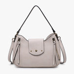 Light gray handbag with tassels and a strap close-up