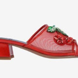 Red heel with decorative cherry elements close-up