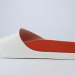 White sandal with a red sole inside