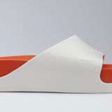 White sandal with a red sole close-up