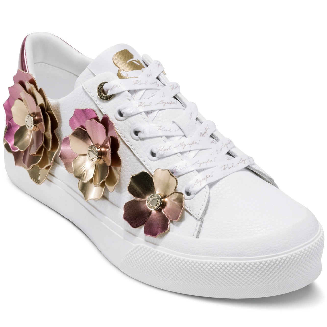 White sneaker with rose gold floral embellishments close-up