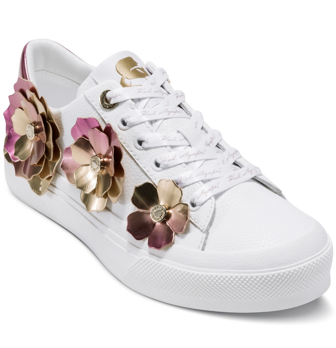 White sneaker with rose gold floral embellishments close-up