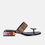 Black sandal with colorful gemstones and toe post close-up