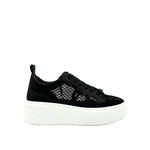 Black mesh sneaker with a white sole close-up