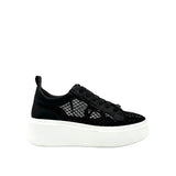 Black mesh sneaker with a white sole close-up