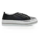 Black sneaker with gray sole close-up