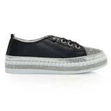 Black sneaker with gray sole close-up