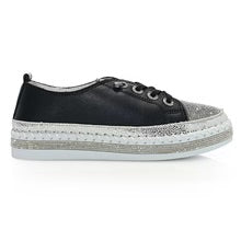 Black sneaker with gray sole close-up