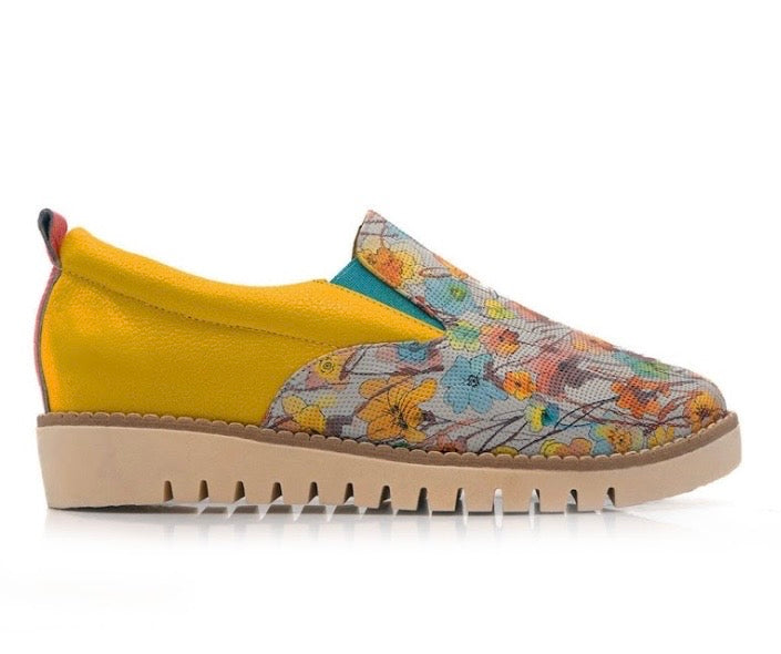 Yellow slip-on shoe with floral pattern close-up