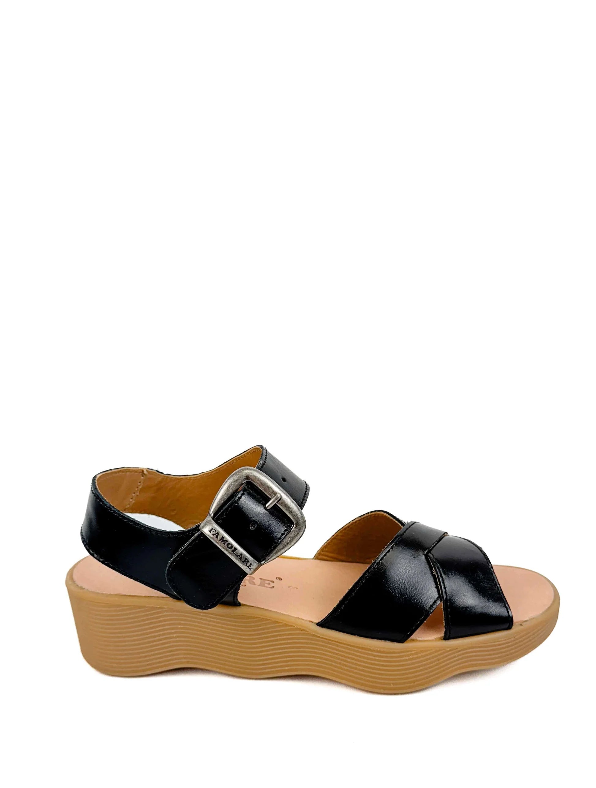 Black sandal with a brown sole close-up
