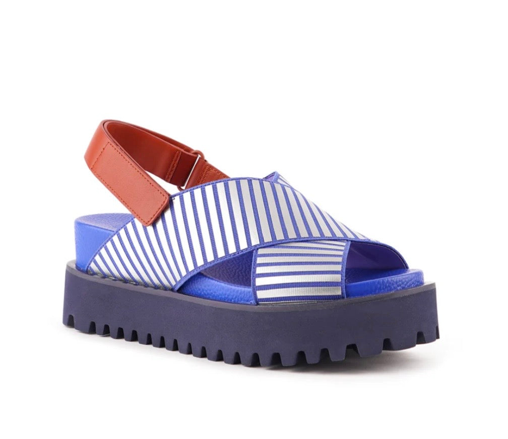 Blue and white striped sandal with a brown strap on a white background
