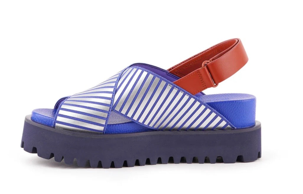 Blue and white striped sandal with a brown strap on a white background