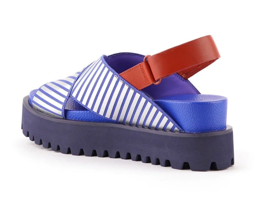 Blue and white striped sandal with a brown strap on a white background