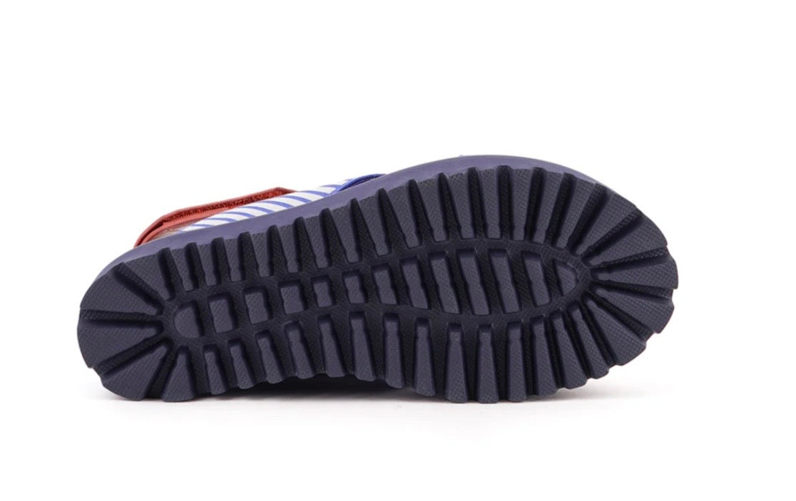Close-up of a pair of boots with a focus on the sole on a white background