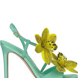 Mint green high-heeled heel with yellow floral decorations close-up