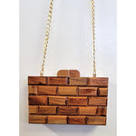 Wooden handbag with a gold chain strap closeup
