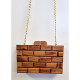 Wooden handbag with a gold chain strap closeup