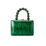 Green marbled handbag with beaded handle on a white background