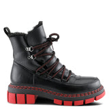 A black faux-leather lace-up winter boot with a red sole, red stitching, and red laces, featuring a faux-fur lining at the collar and silver metal eyelets.
