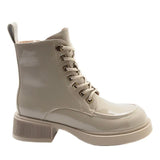 A single light beige patent leather lace-up ankle boot with a chunky ribbed block heel and metal eyelets, shown from a side profile on a white background.