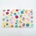 Colorful patterns on a white pouch close-up