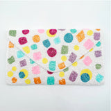 Colorful patterns on a white pouch close-up