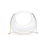 A clear acrylic evening bag with a structured shape and a gold chain strap.