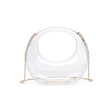 A clear acrylic evening bag with a structured shape and a gold chain strap.