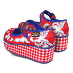 A pair of red and blue checkered Mary Jane platform shoes with a printed fabric upper and a customizable buckle strap, featuring a non-marking rubber sole heel