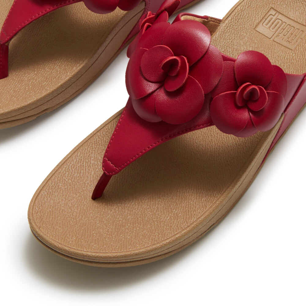Red sandal with floral design and copper heel top view