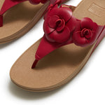 Red sandal with floral design and copper heel top view