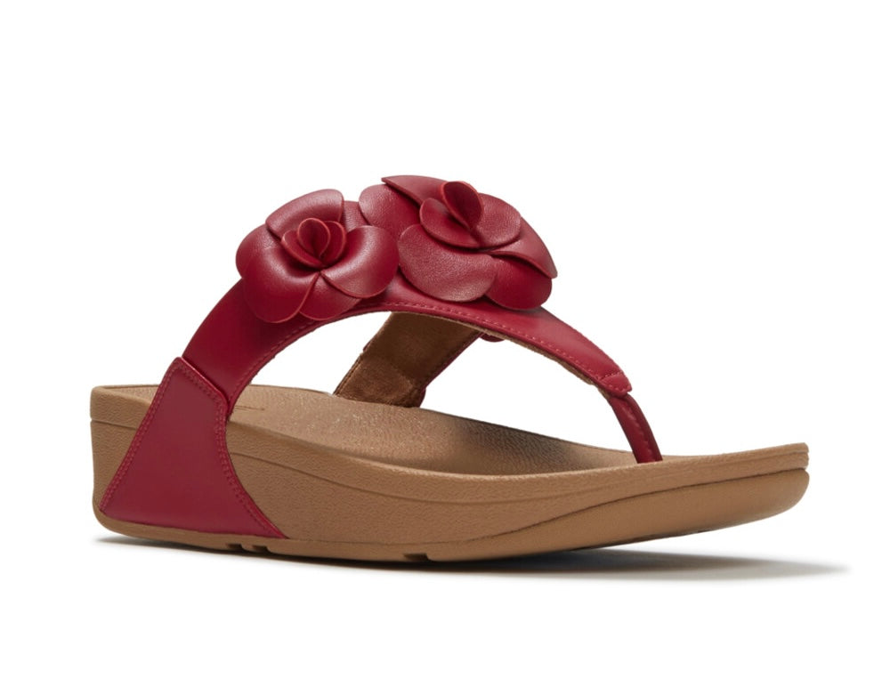 Red sandal with floral design and copper heel close-up