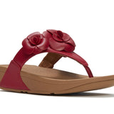 Red sandal with floral design and copper heel close-up