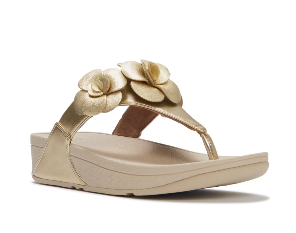 Gold sandal with floral design and gold heel close-up