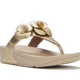 Gold sandal with floral design and gold heel close-up