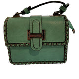 Green handbag with braided details closeup