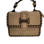 Beige handbag with studded details closeup