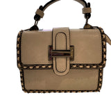 Beige handbag with studded details closeup