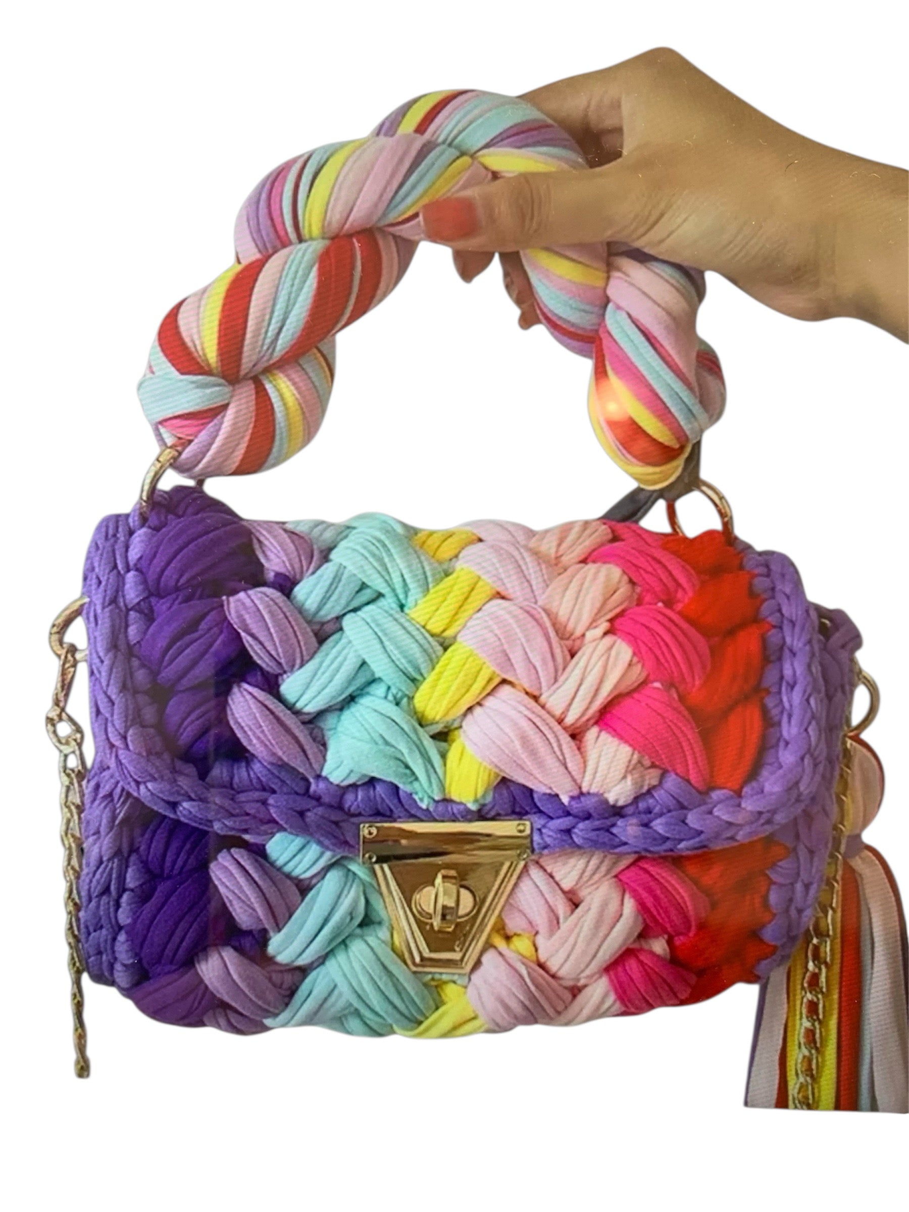 Colorful woven handbag with a braided handle closeup