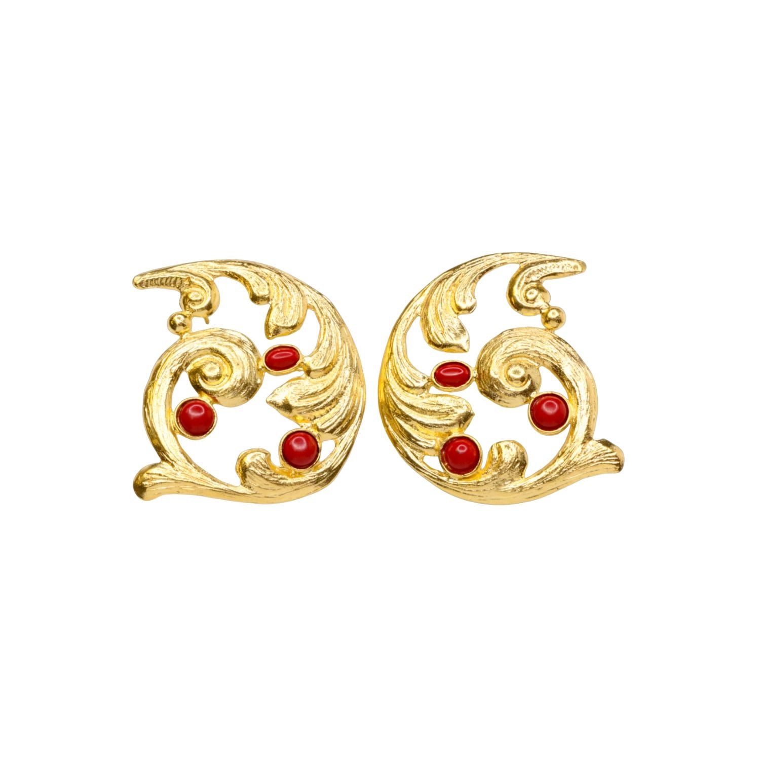Pair of gold colored earrings with red stones accents on a white background