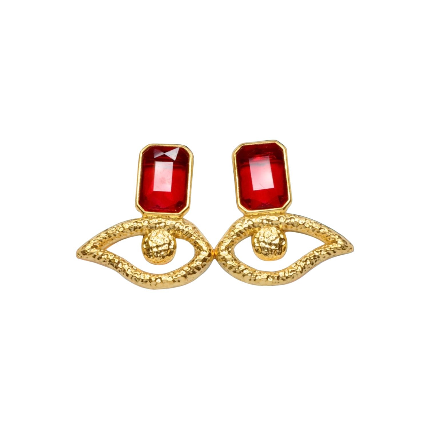 Gold colored eye shaped earrings with red crystal accents on a white background
