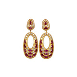 Gold colored earrings with dark magenta and white crystal accents on a white background