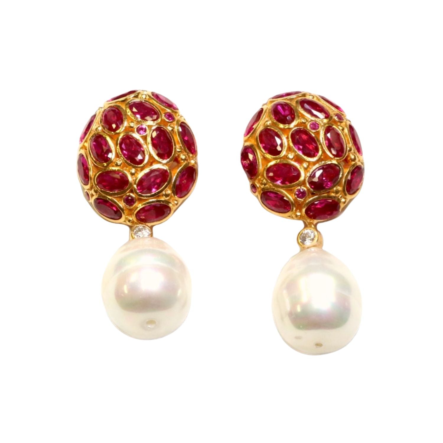 Pair of earrings with dark magenta crystals and pearl like drop accents on a white background