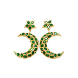 Gold colored moon and star shaped earrings with green crystal accents on a white background
